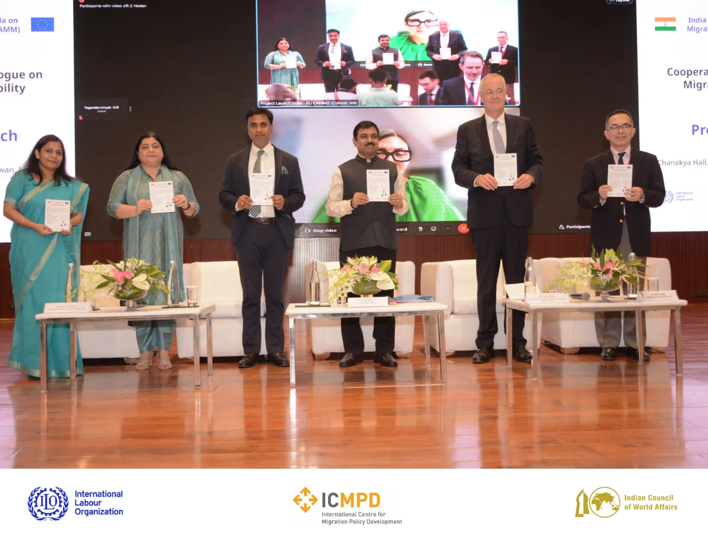 Dignitaries from India, EU and the ILO standing at the launch event with the project brochure in their hands