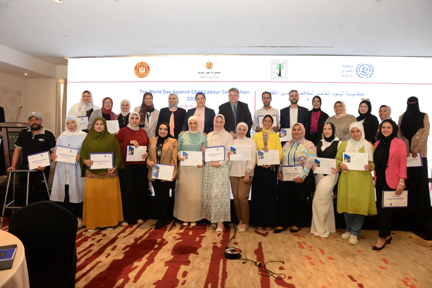 Women pose with graduation certificates