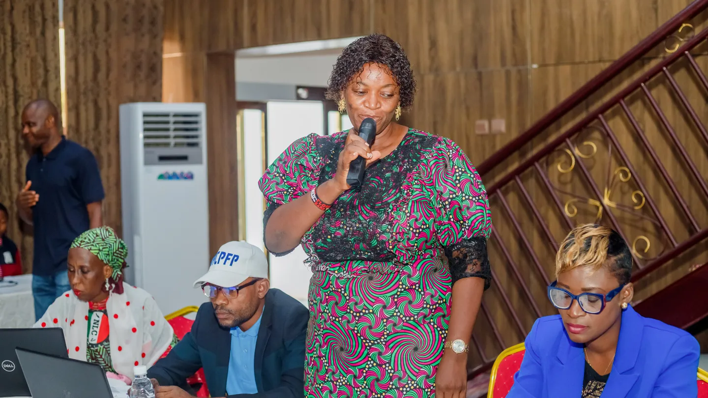 A female member of Ondo State's technical working group on social protection speaks to her colleagues