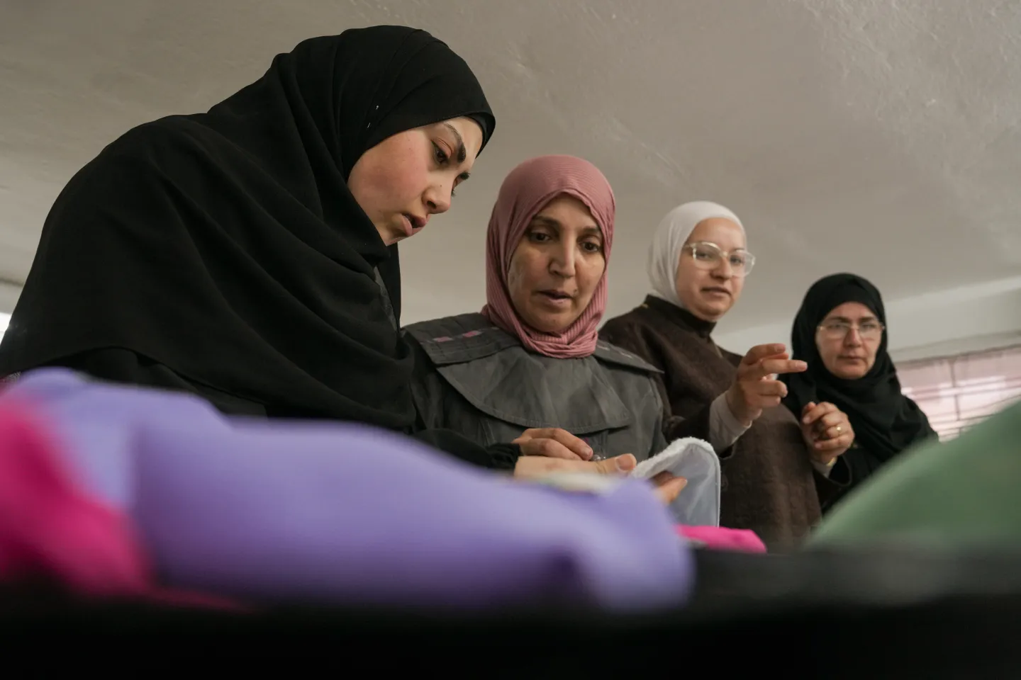 women employees discussing fabrics