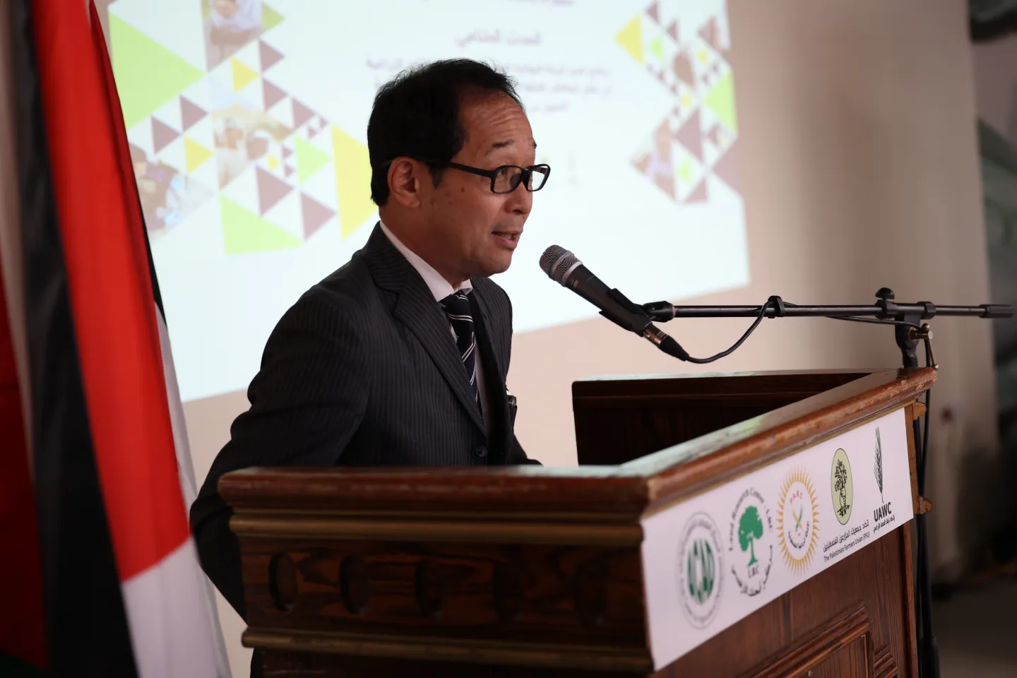 Japanese ambassador giving a speech on a lectern 