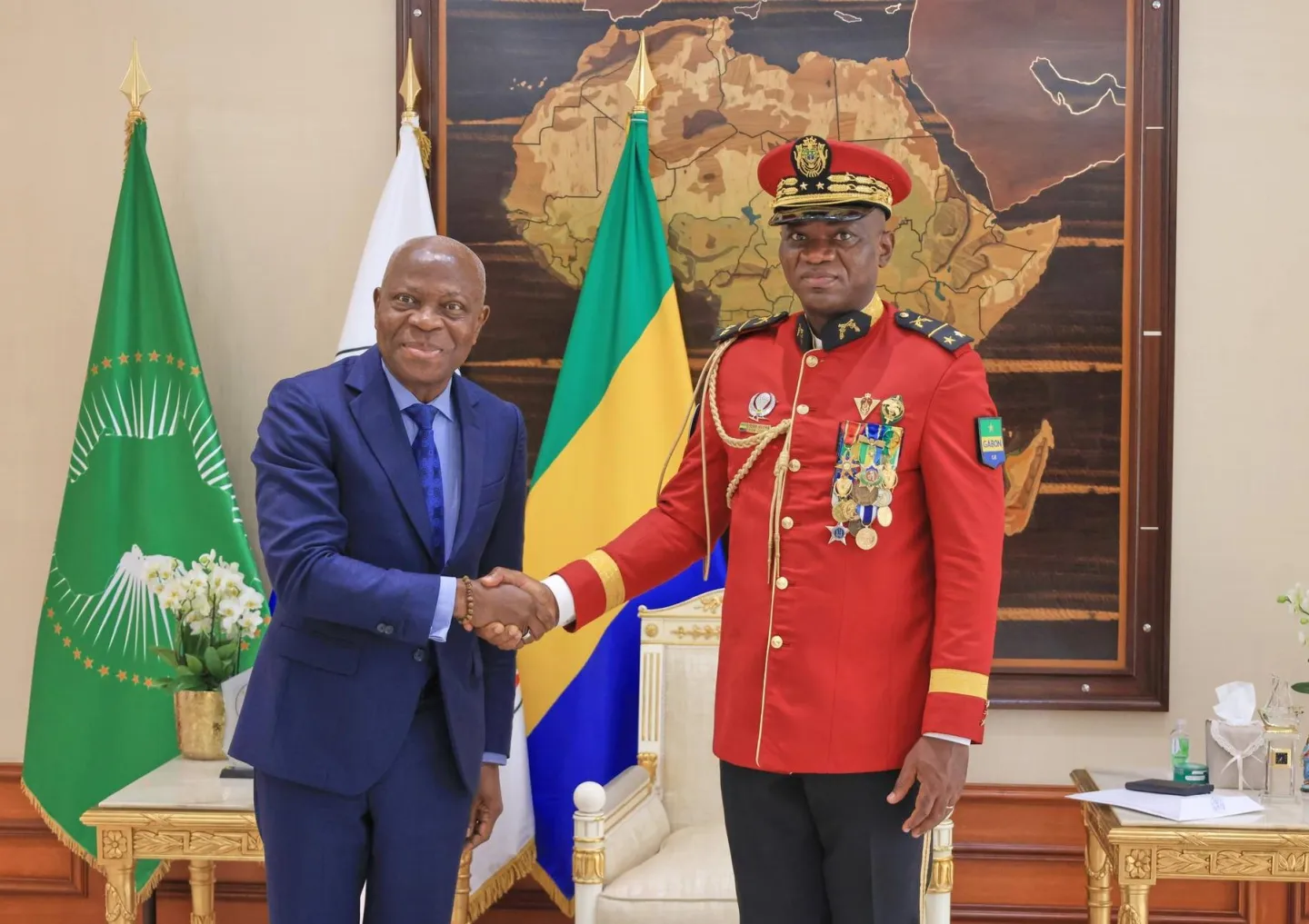 Gilbert F. Houngbo shakes hands with Gabon's President of the Transition, Brigadier General Brice Clotaire Oligui Nguema, on July 1 in Libreville.