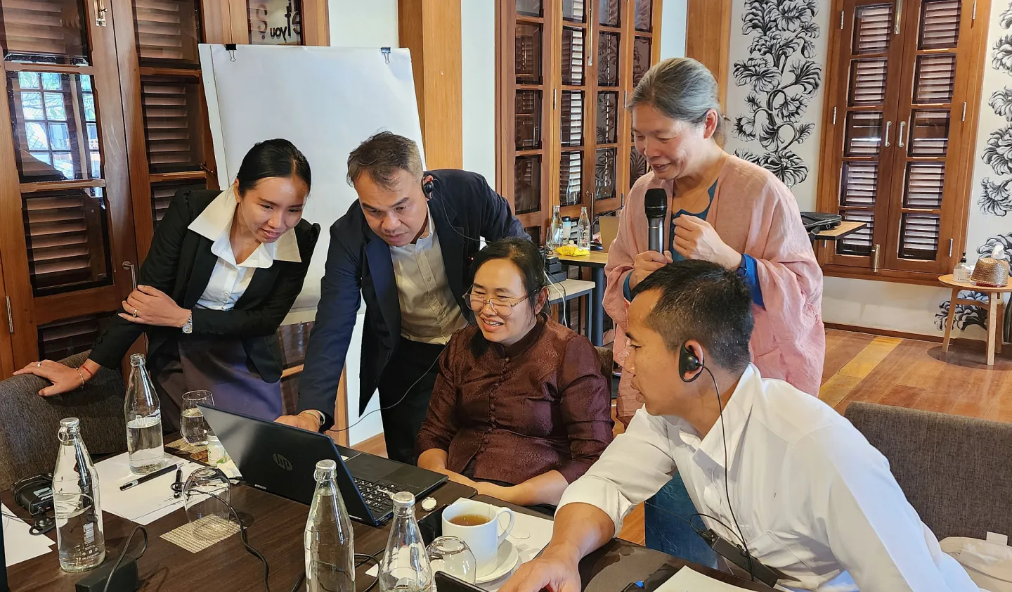 A trainer and participants work together on ILO’s actuarial models in Lao People's Democratic Republic.