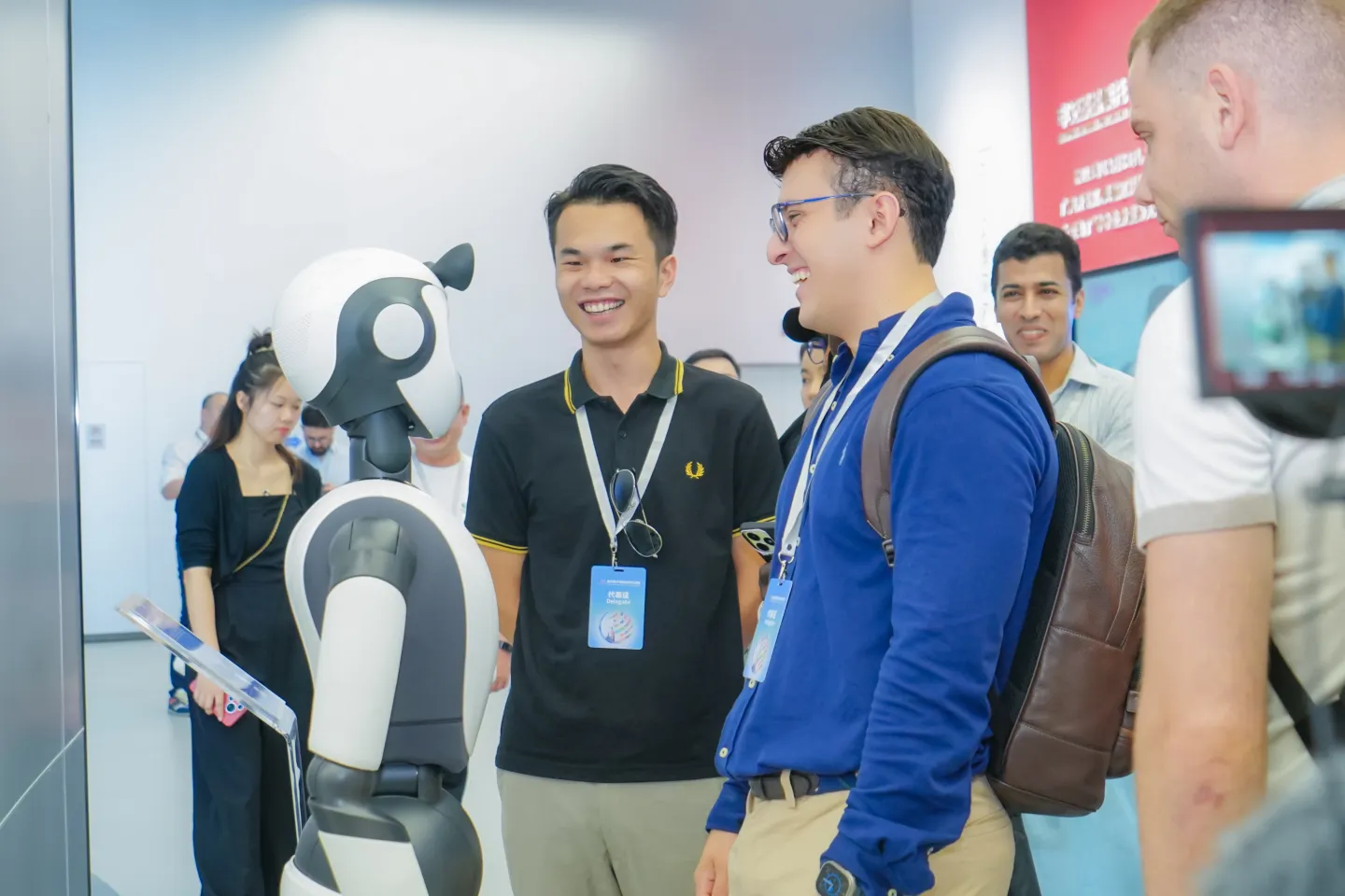 Youth representatives interacting with AI robots © ILO