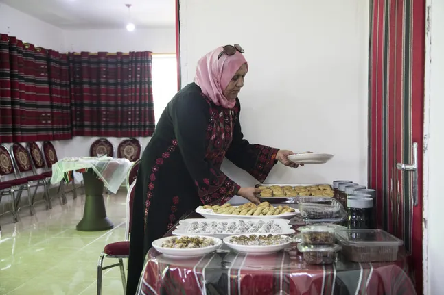woman arranging baked products