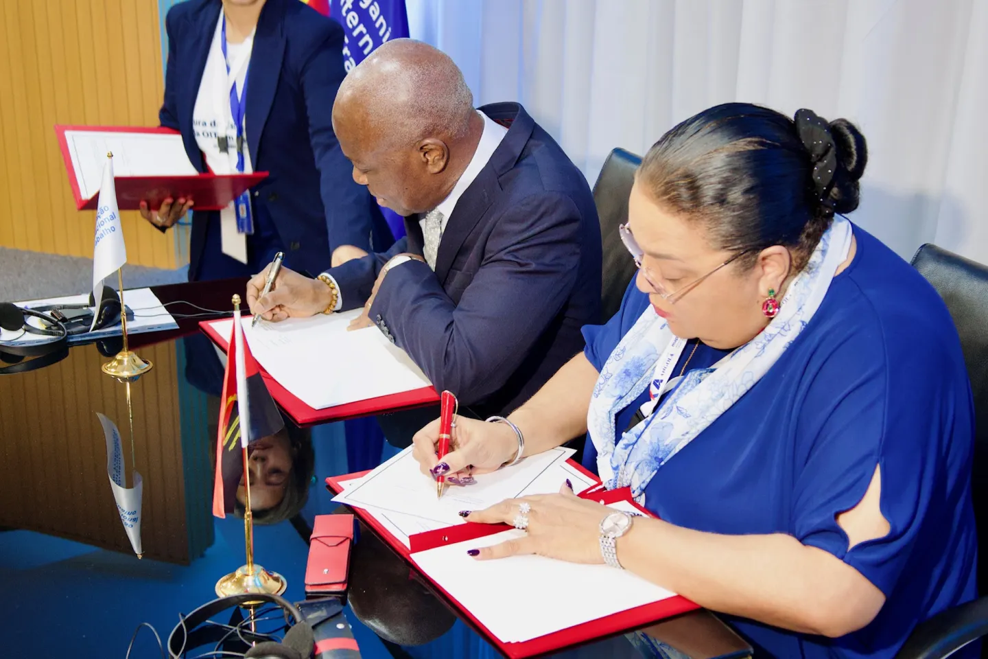 ILO Director-General Gilbert F. Houngbo and the Minister of Public Administration, Labour and Social Security of Angola, Teresa Dias Rodrigues, sit and sign the Country Office agreement.