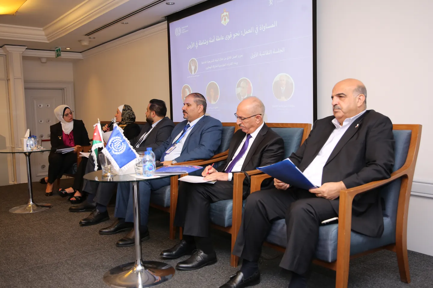 speakers of the pannel sitting on stage and discussing the topic