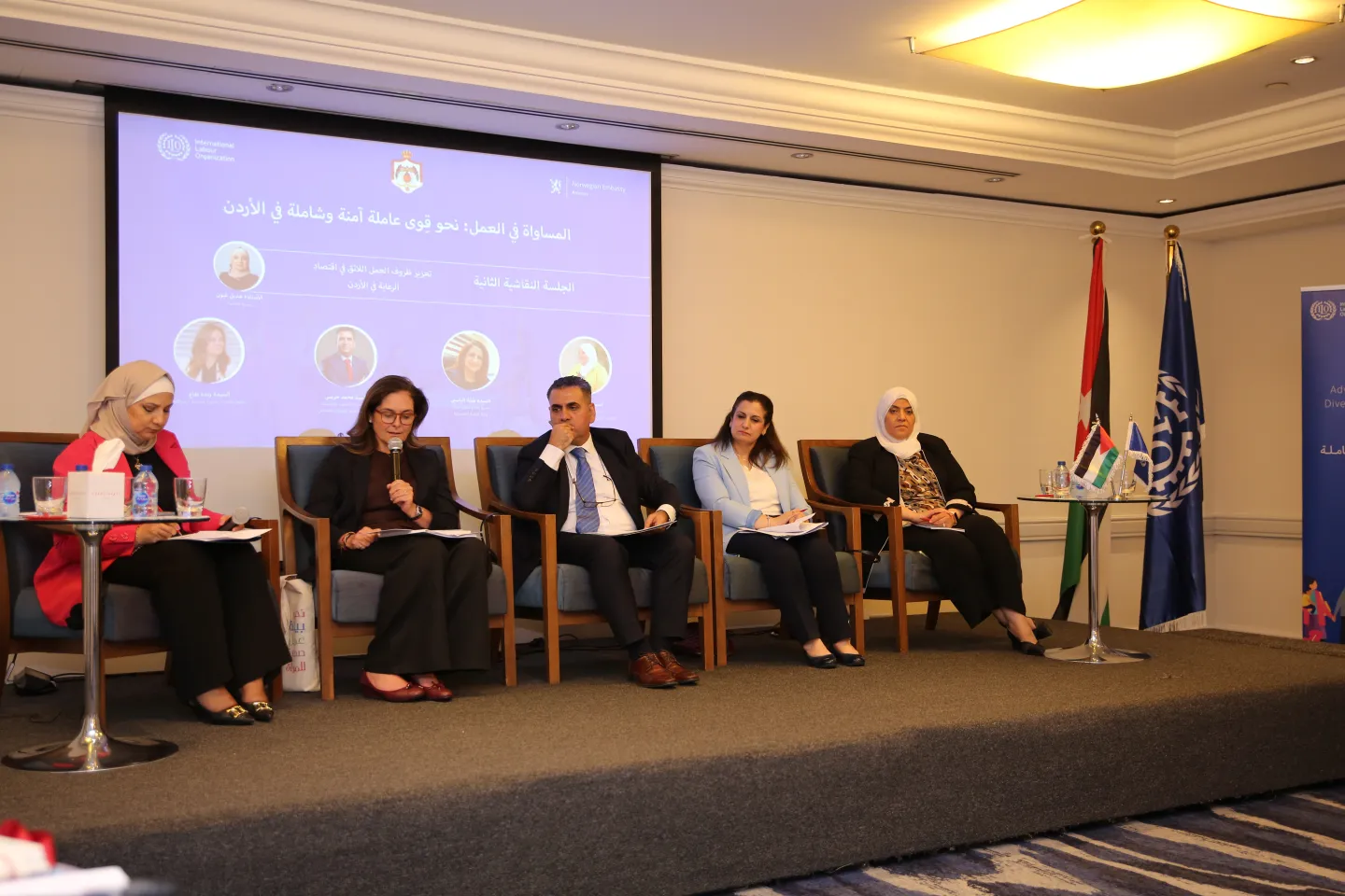 speakers of the pannel sitting on stage and discussing the topic