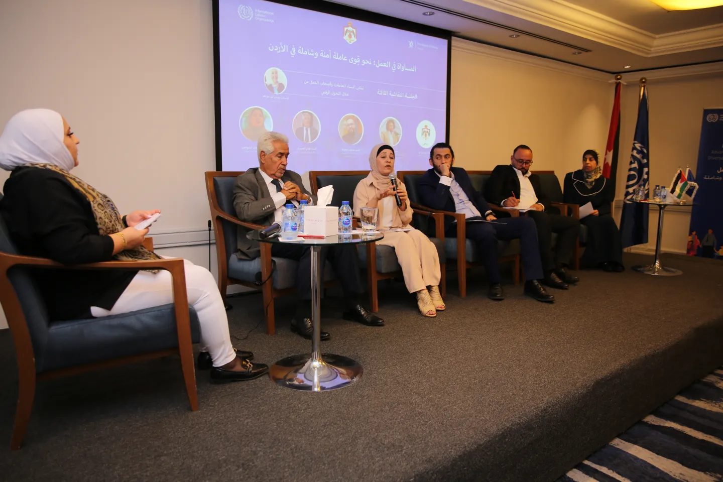 speakers of the pannel sitting on stage and discussing the topic