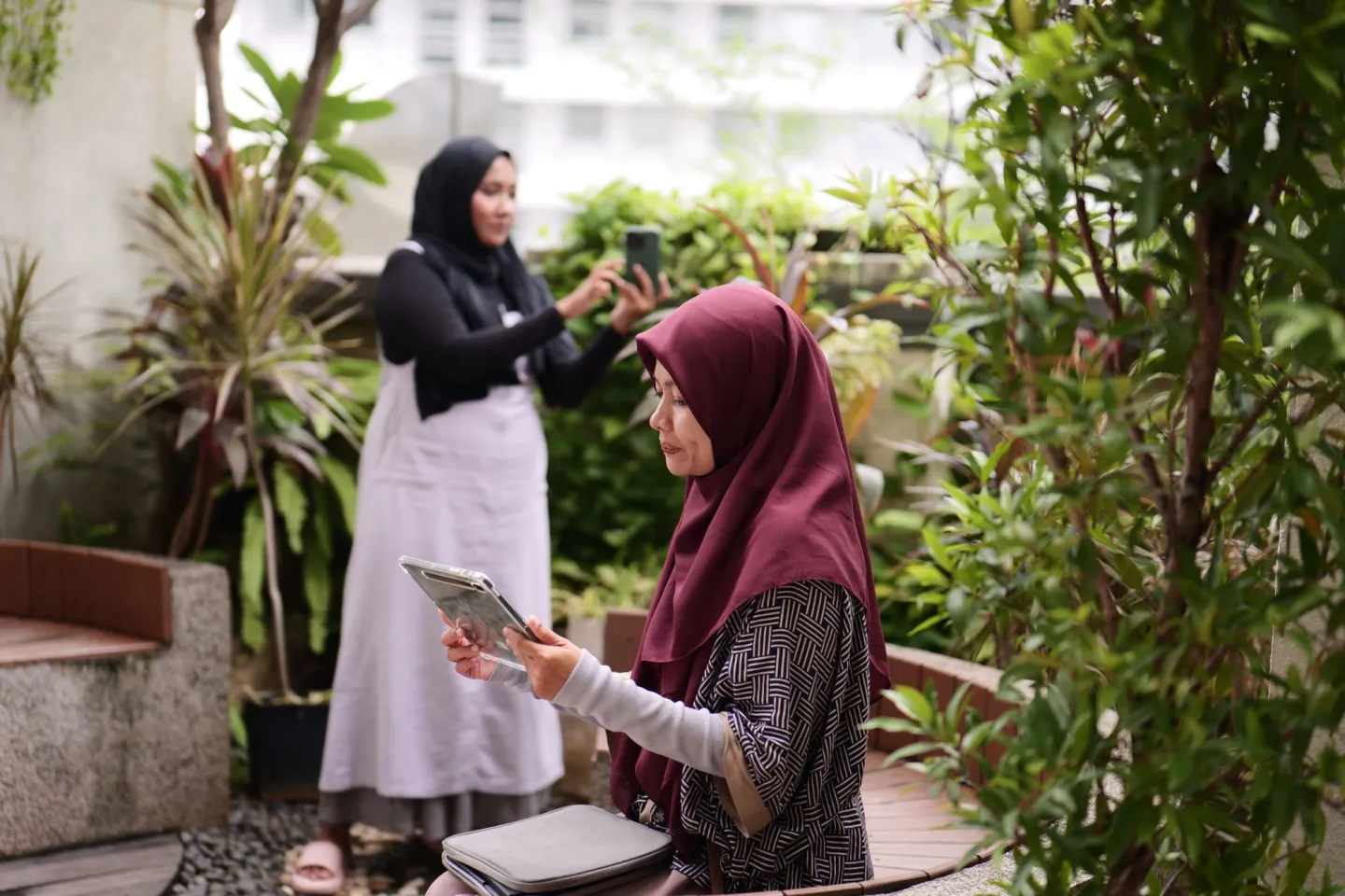 Two participants of ILO social media training on care economy are producing contents.