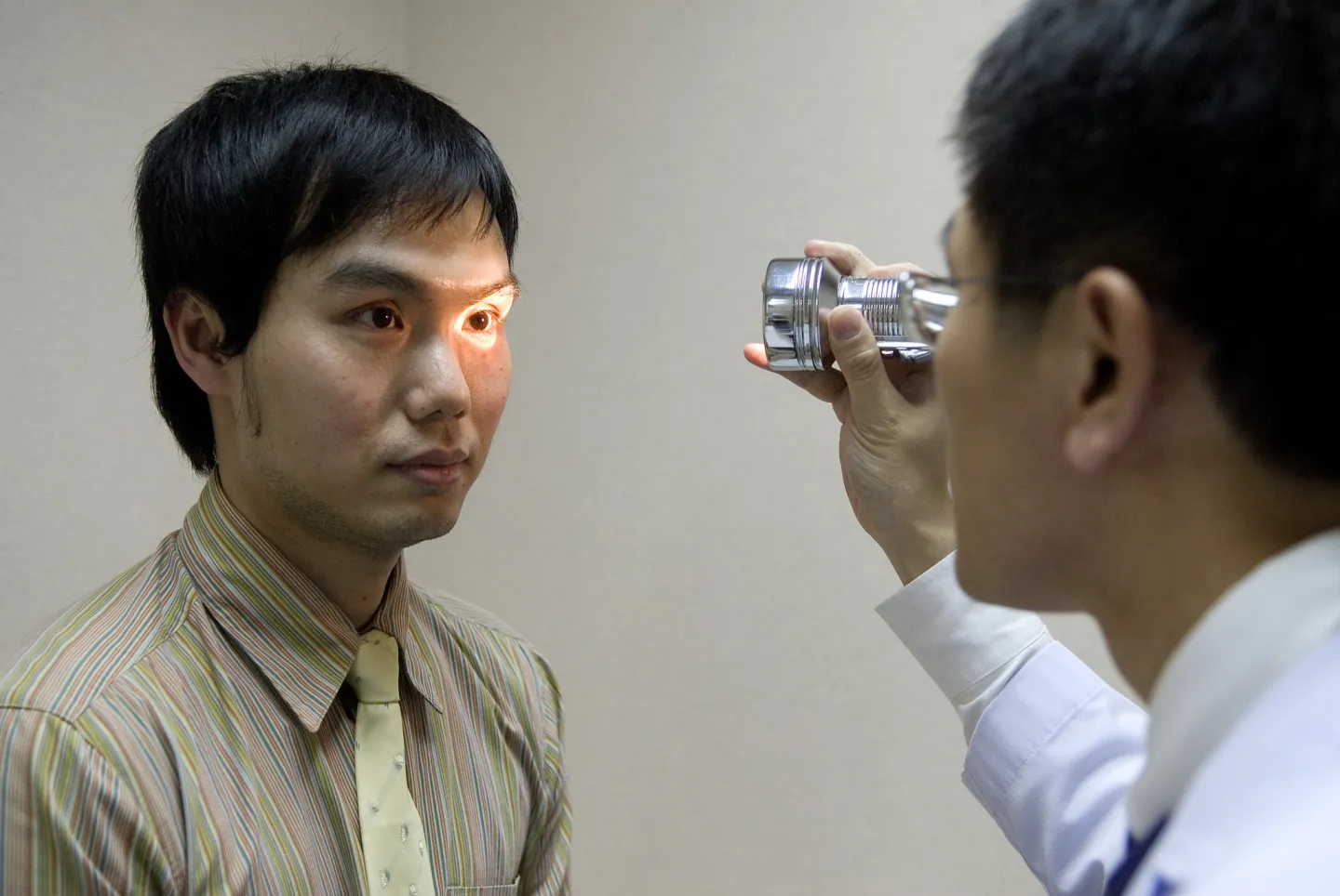 A doctor performs an eye examination on a patient at a hospital in Thailand.