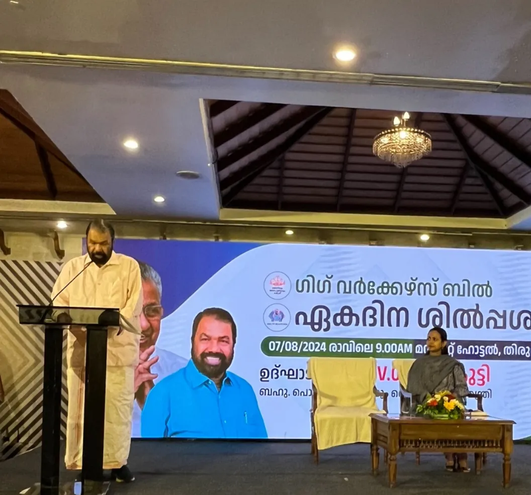 Man standing behind the podium at an event, on a stage