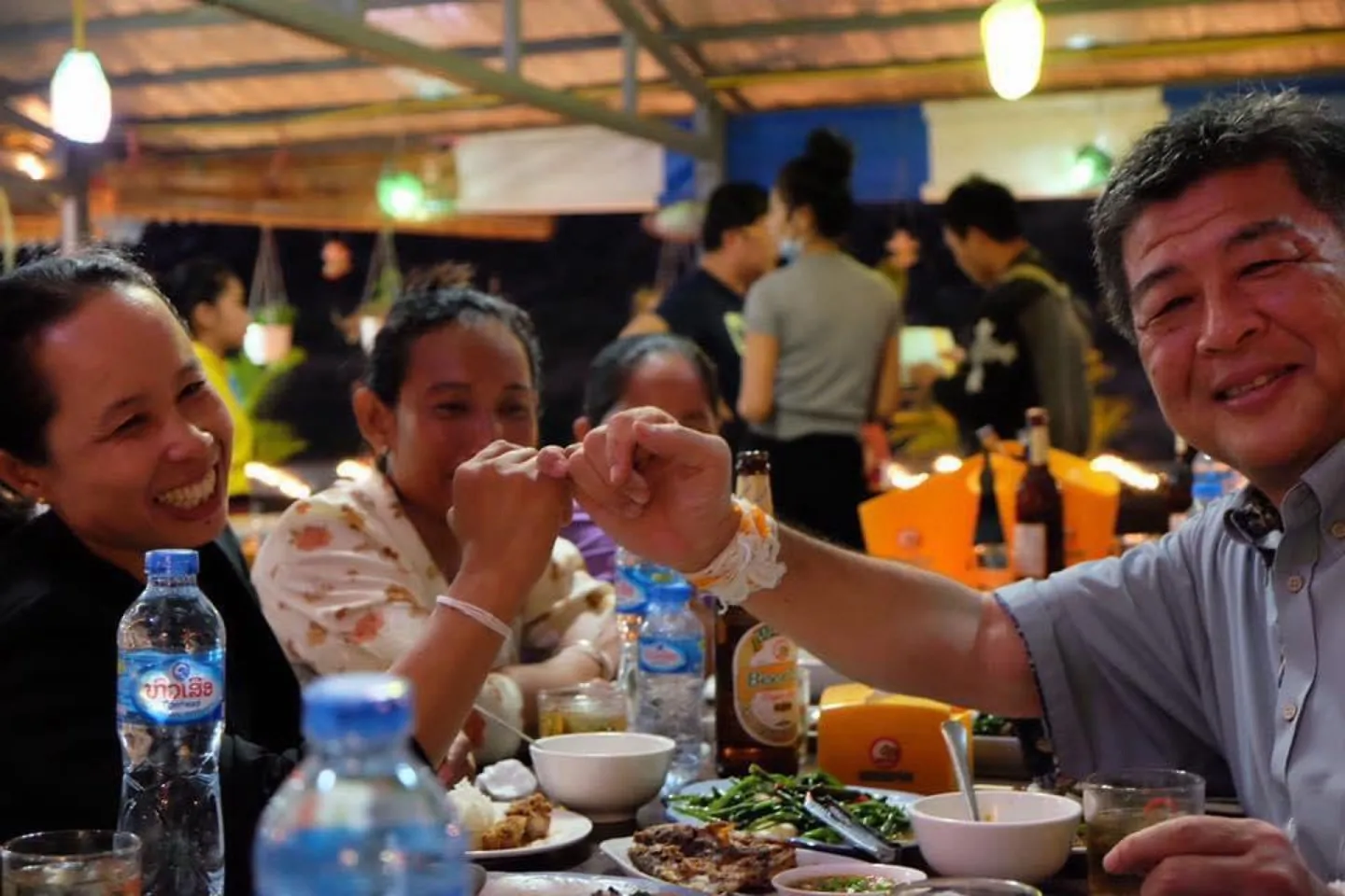 Mr Ishihara of COOP Okinawa and a member of the liquor production group promising to expand the rice liquor cooperative in Attapeu, Lao People's Democratic Republic
