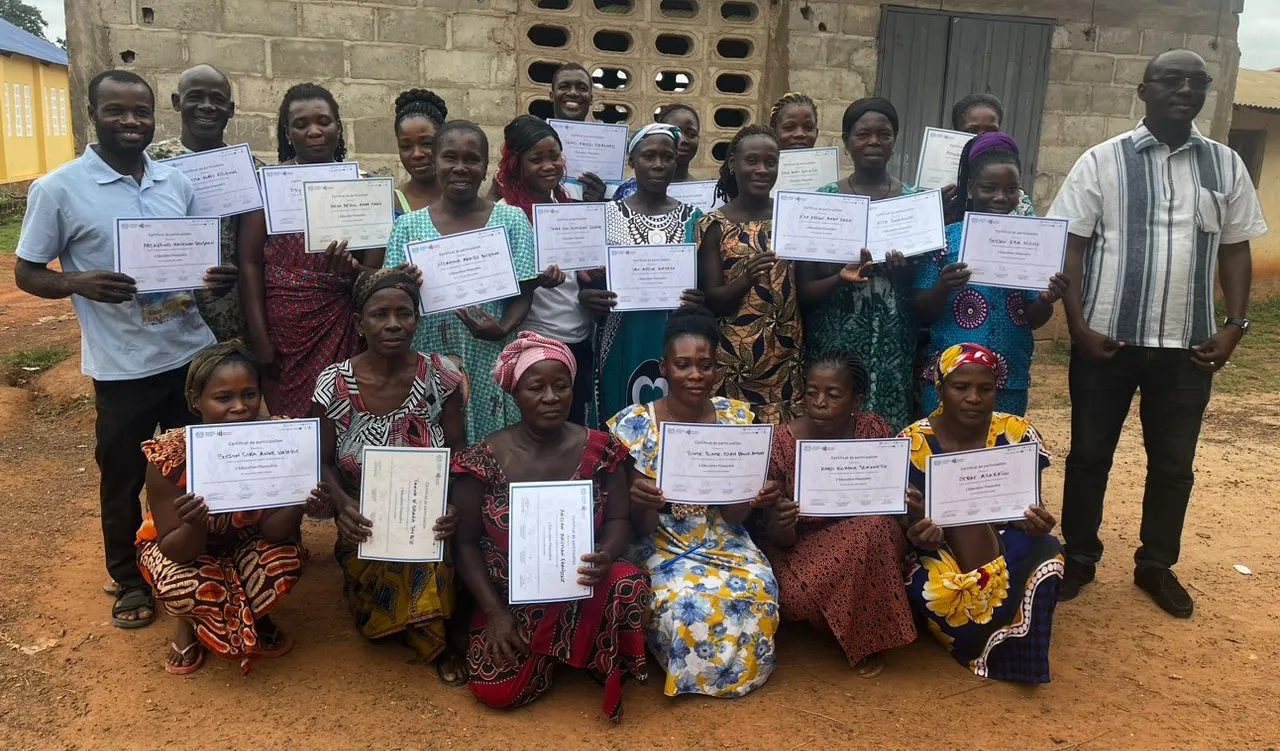 Community members participants of training pose for a group picture