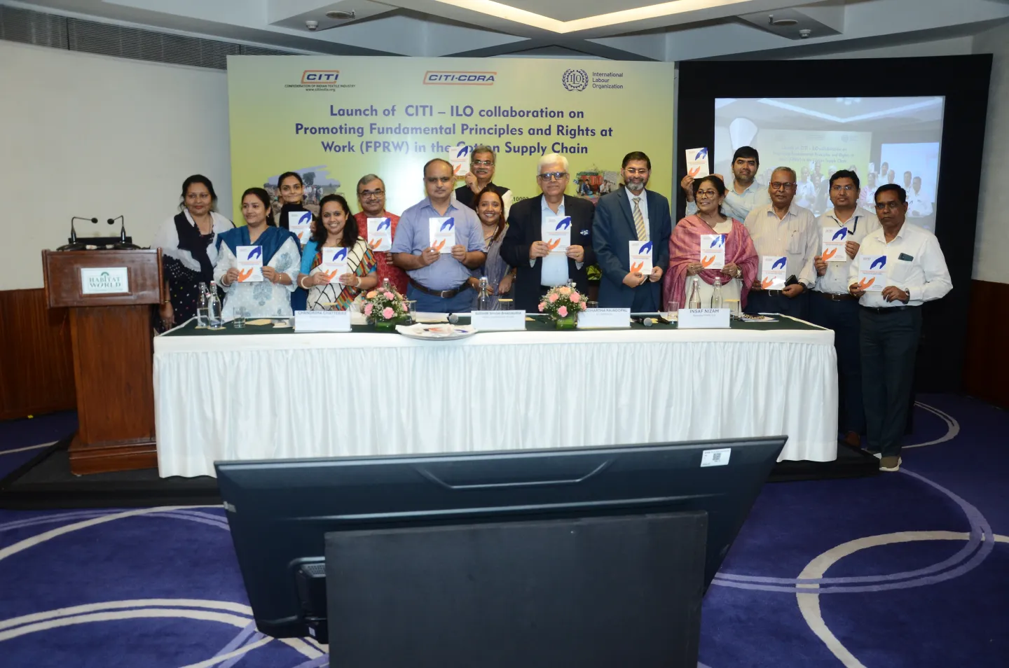 Women and men standing at the dais of an event