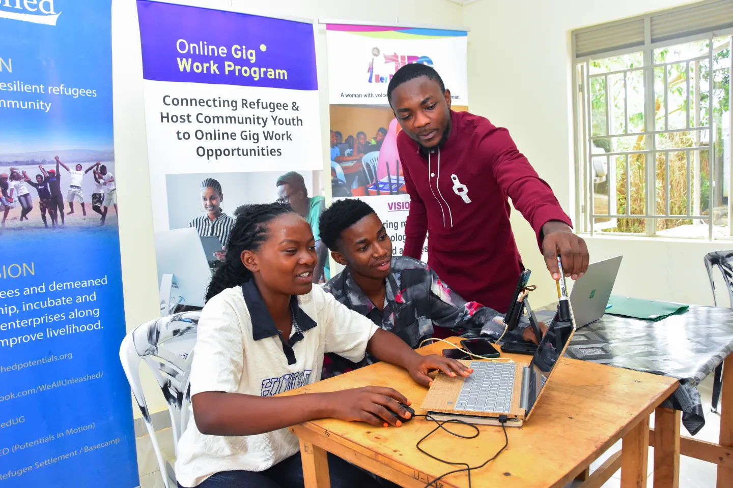 Three trainees working on their laptops
