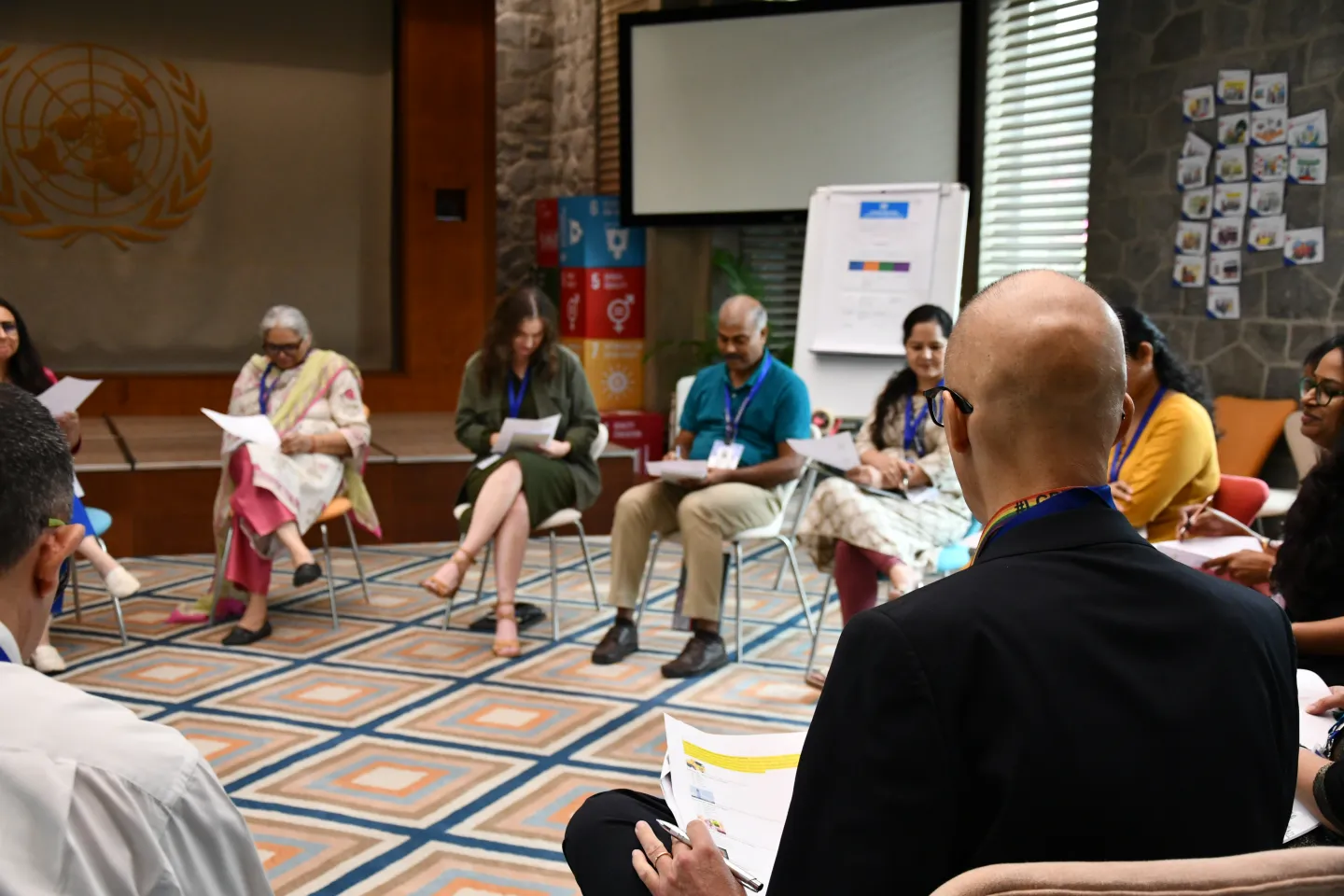 Men and women sitting together in a conference room