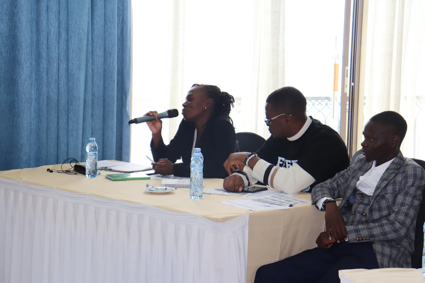 A lady participant to a training speaks in the mic