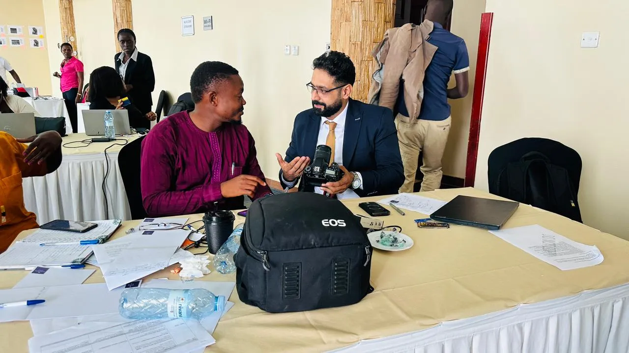 Journalists talk to each other with a camera in their hands
