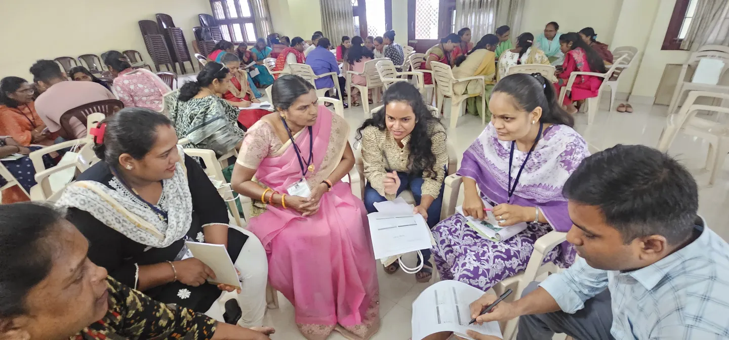 Women and a man sitting together for a discussion