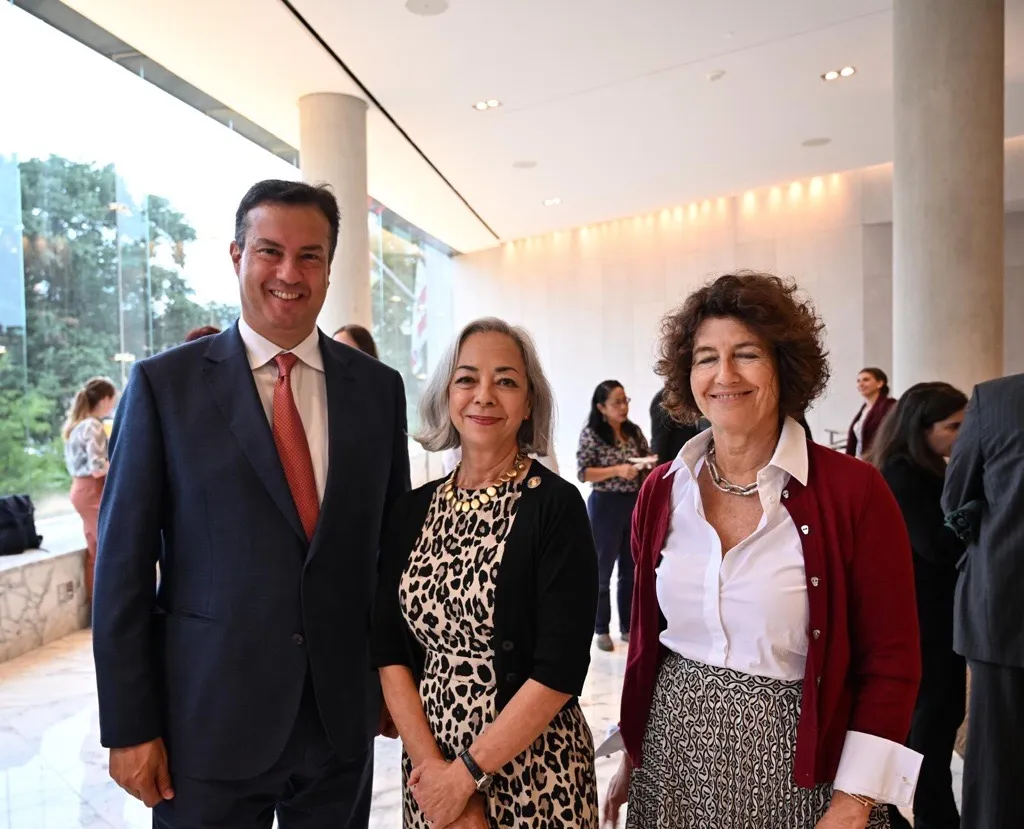 a man and 2 women standing for a picture