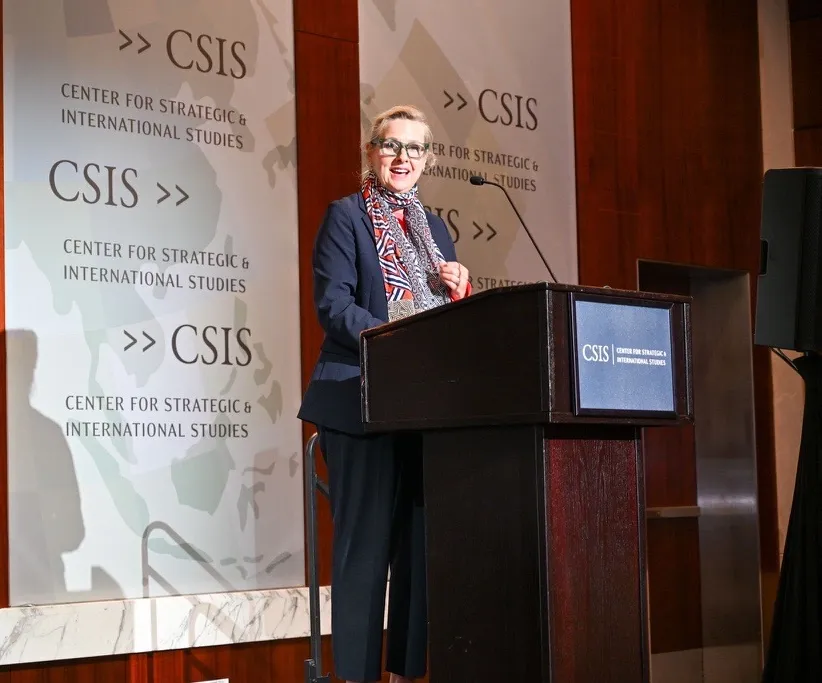 Woman stading behind a podium giving a speech
