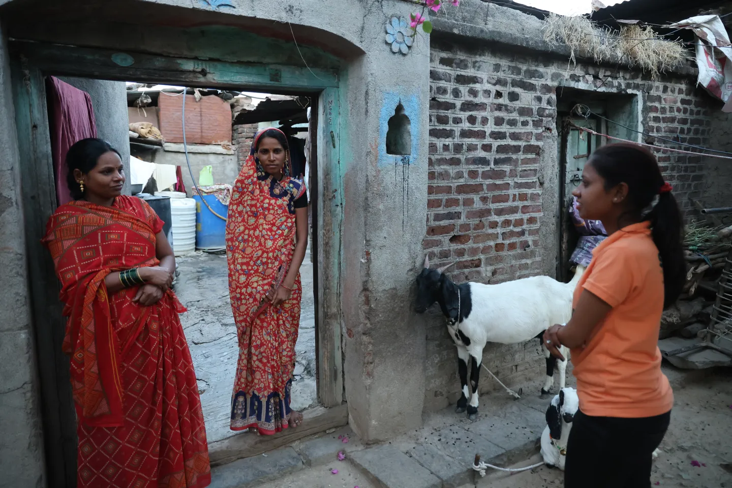 Women standing together at the entrance to a house in rural India