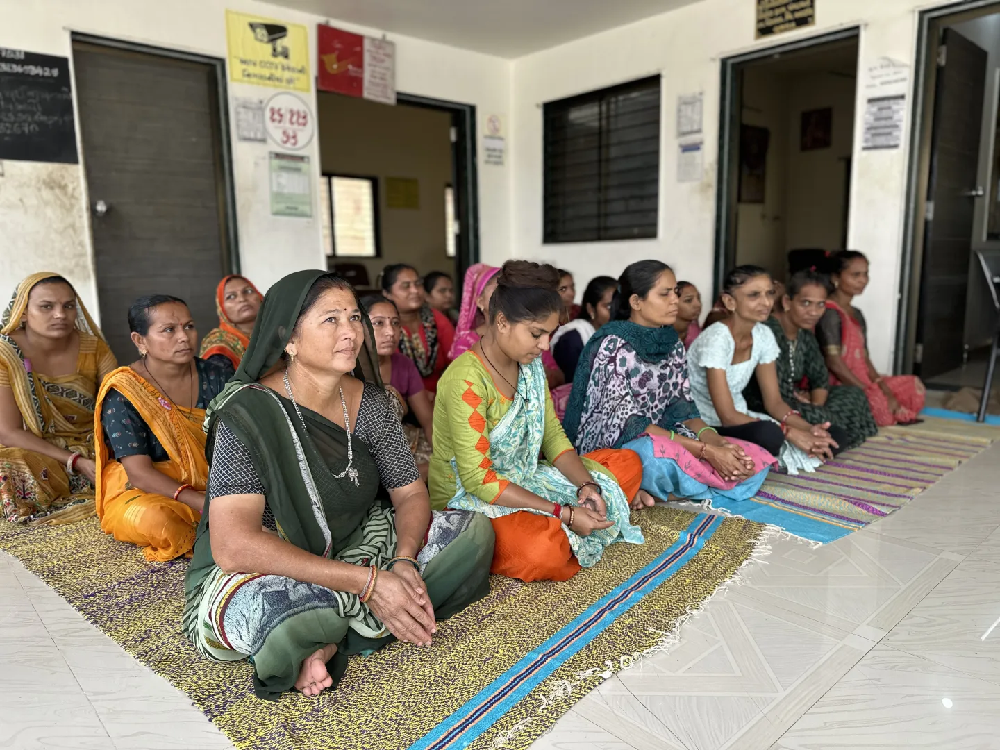 Women sitting together in a village for a meeting