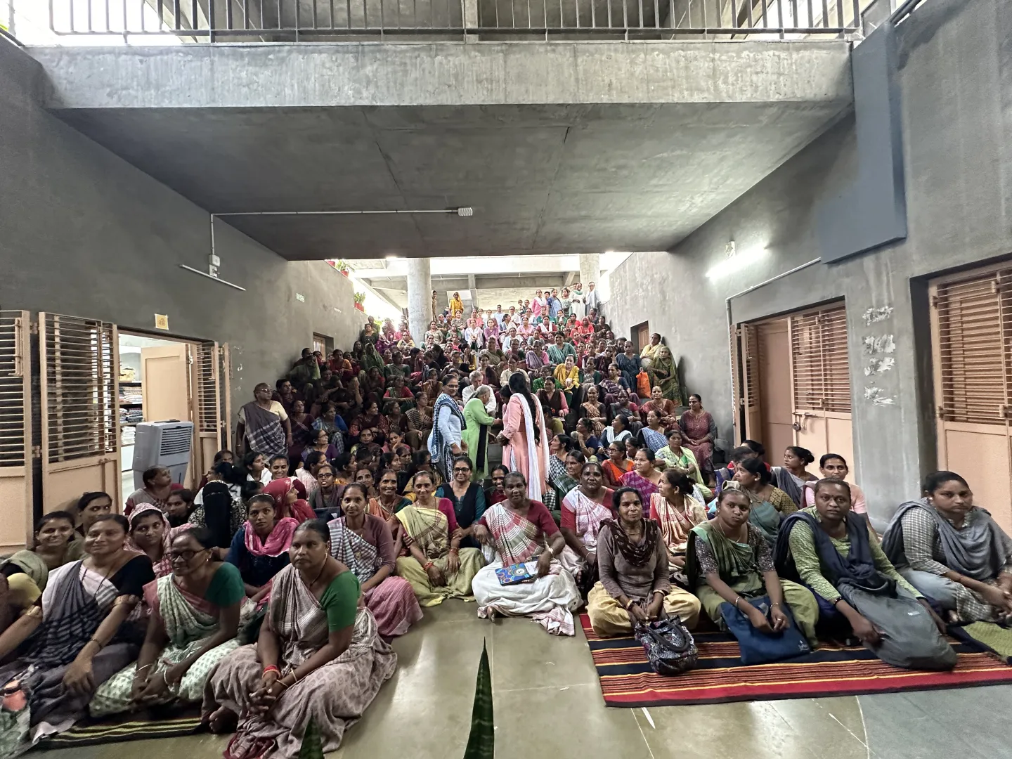 Hundreds of women sitting in a massive amphitheatre 
