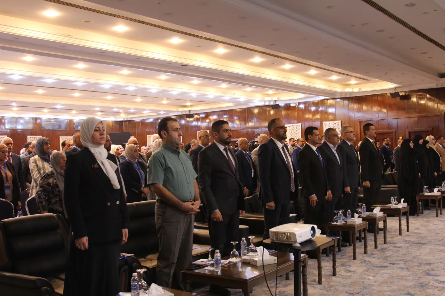 Attendees of the National Conference on “Informal Work and Pathways to Decent Work in Iraq”, standing for the national anthem