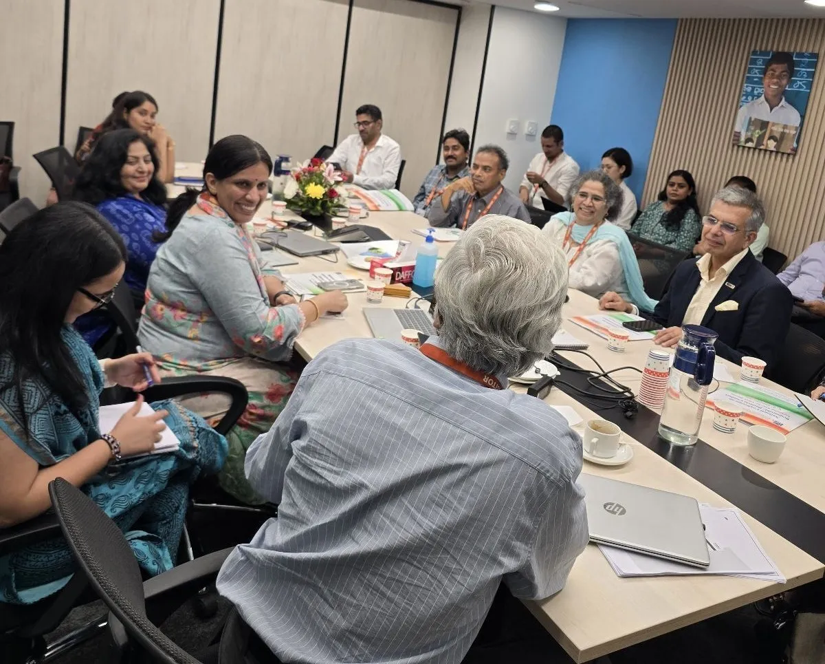Women and men sitting together in a conference room