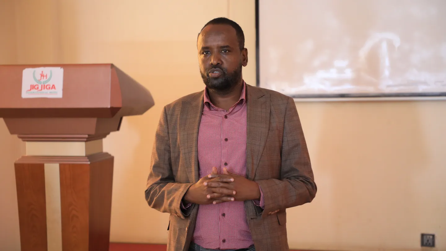 Man speaking infront of a group of young people