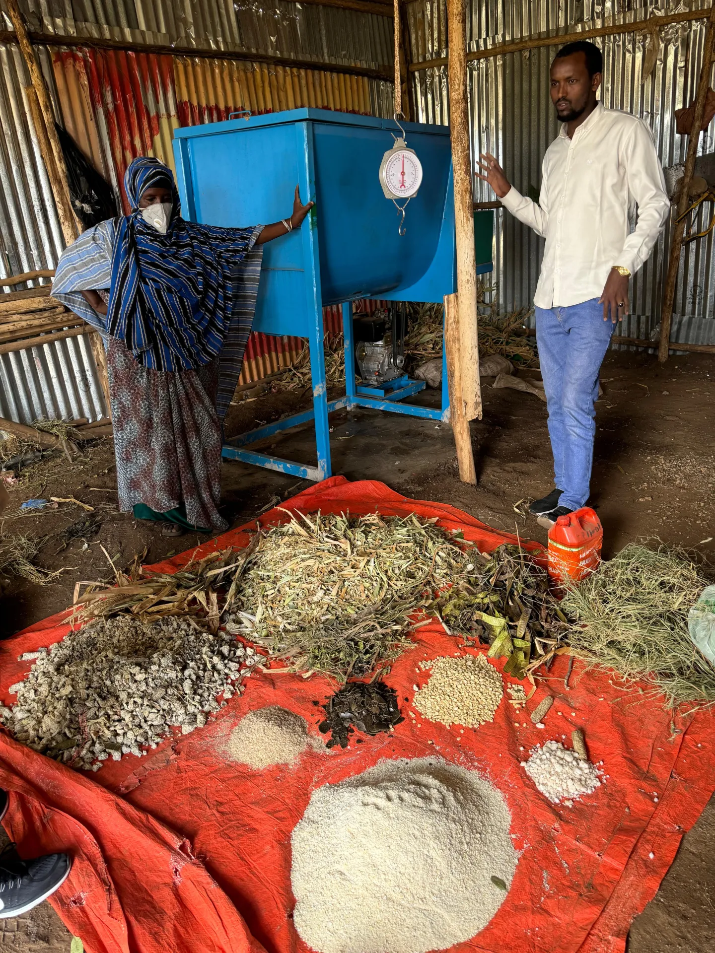 man and woman standing near agriculture machinery