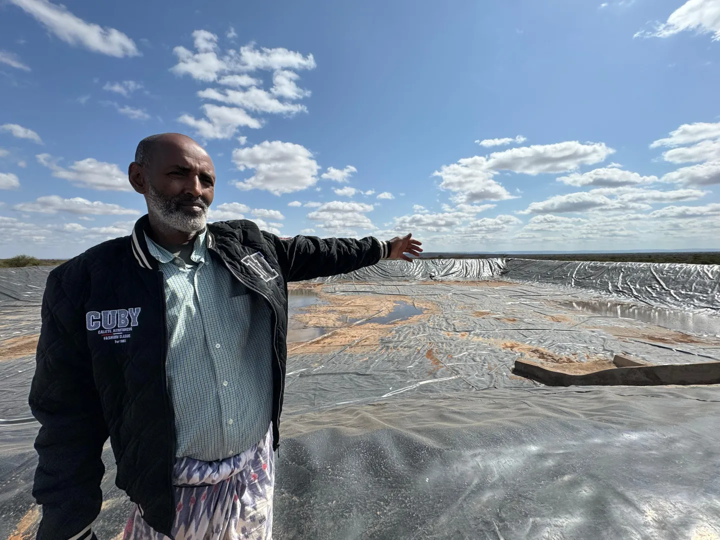 man showing an empty water pond