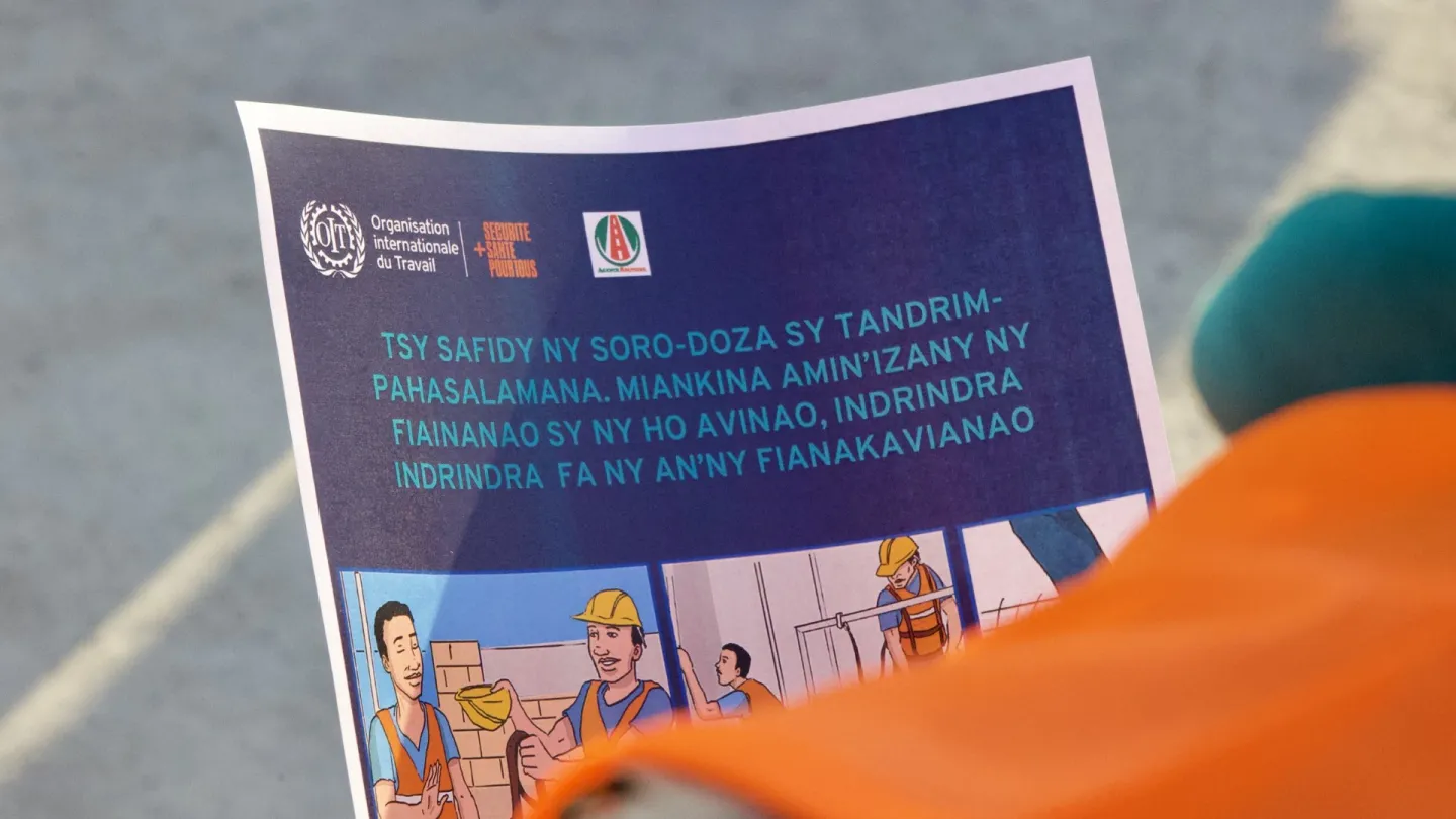 Close up on an Occupational Safety and Health fact-sheet held by a construction worker during a presentation on OSH organized by the VZF Project in Madagascar on 28 October 2024.
