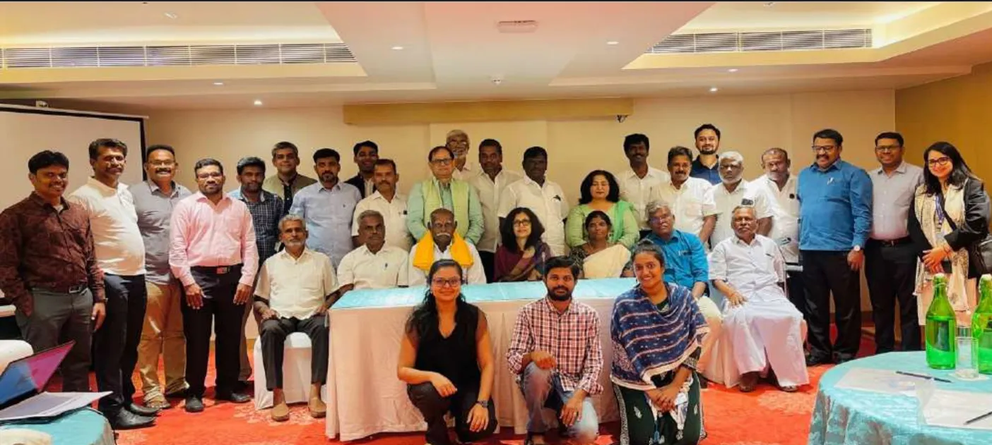 Women and men standing together in a conference room