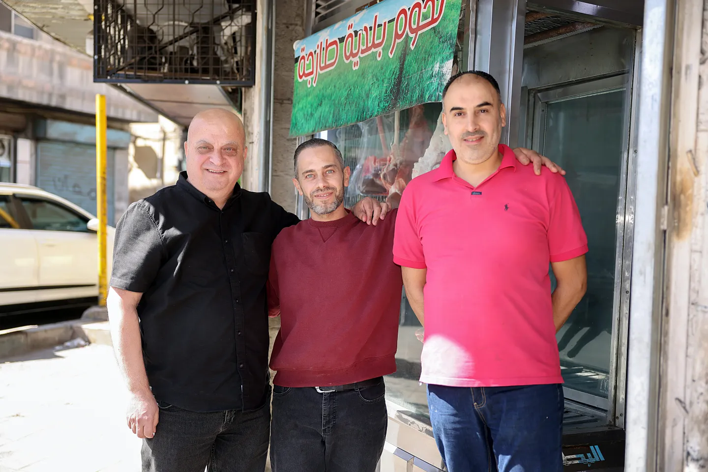 Eyad stands between a fellow worker (R) and the shop owner at the butcher shop in Zarqa© ILO/ Issa Dahdal 