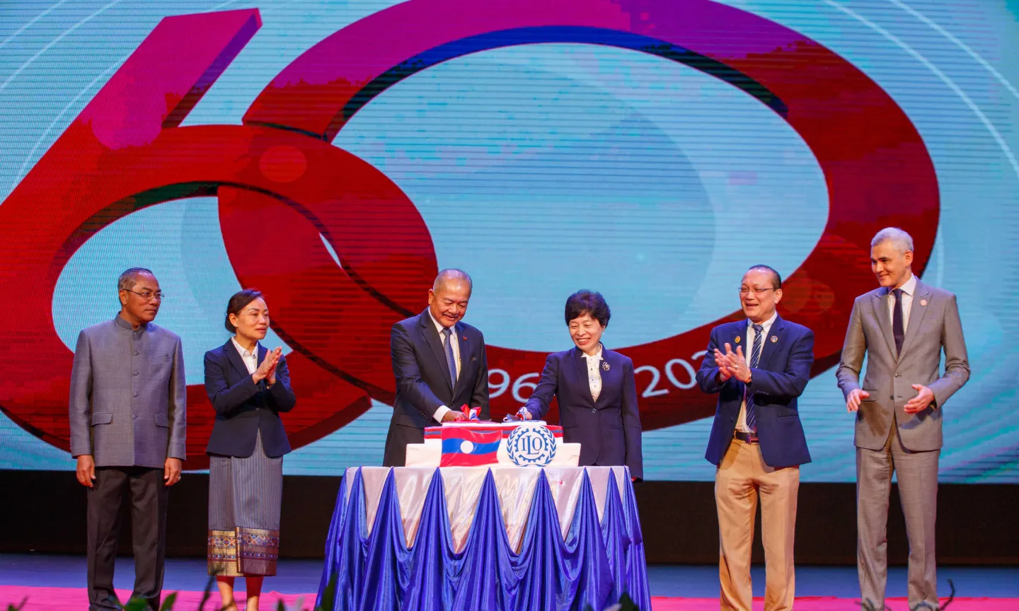 Representatives of the Lao government, workers' and employers' organizations, and the ILO on the stage.