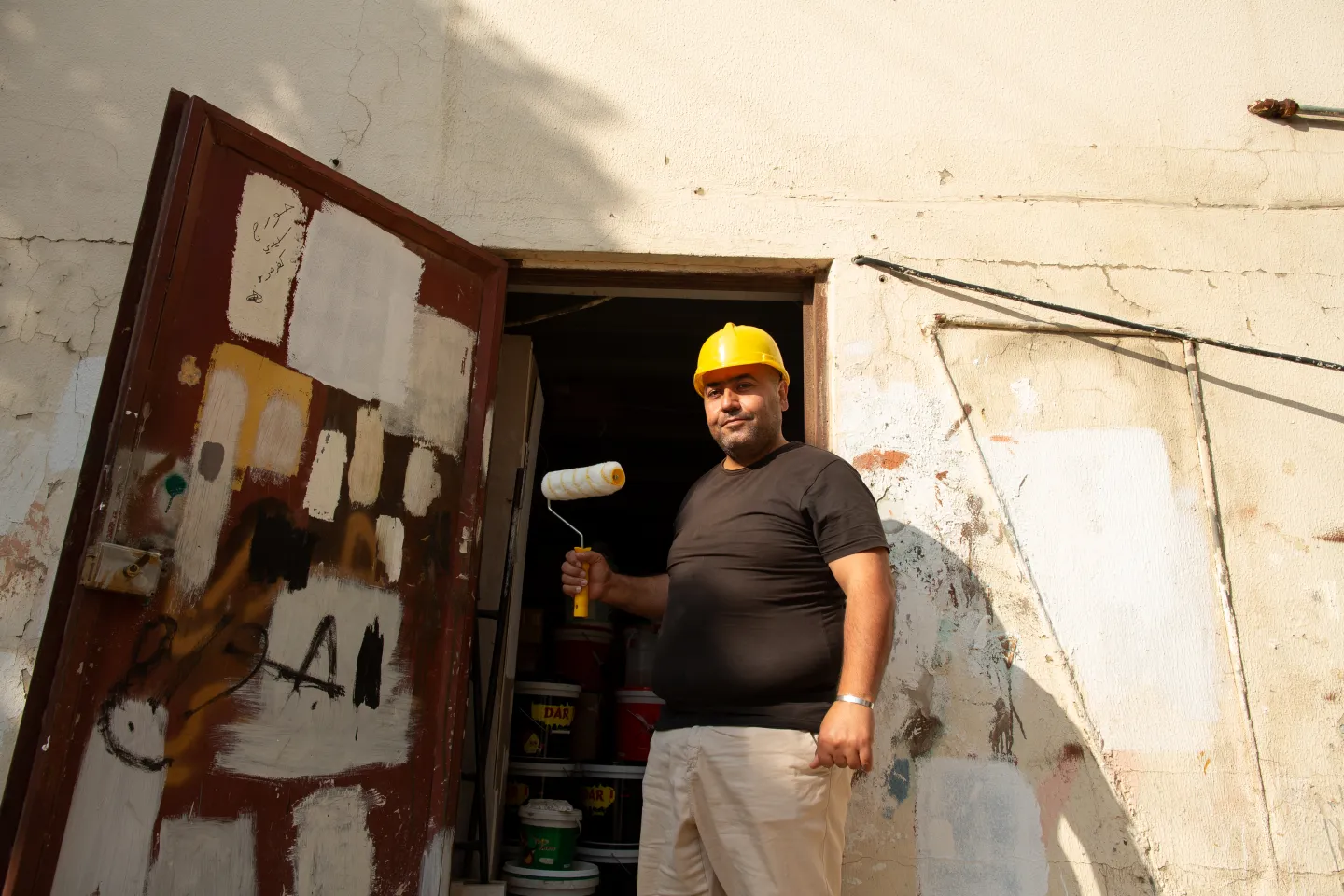a painter outside his shop