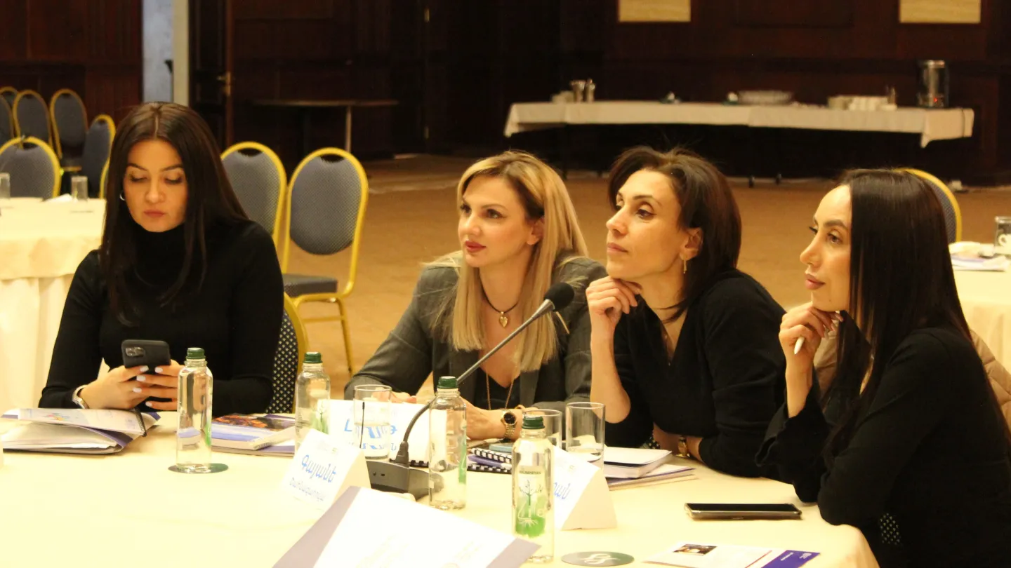 Four participants of the workshop listen to the presenter. Armenia, 2024