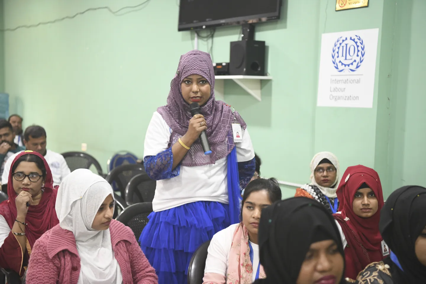 A migrant worker asking a question during the ILO's delegation visit to one of participating in the Better Work Jordan Programme in the Al Hassan Industrial Zone, Jordan. 12 December 2024.