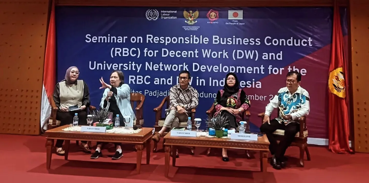 A panel discussion with five people sitting on the stage