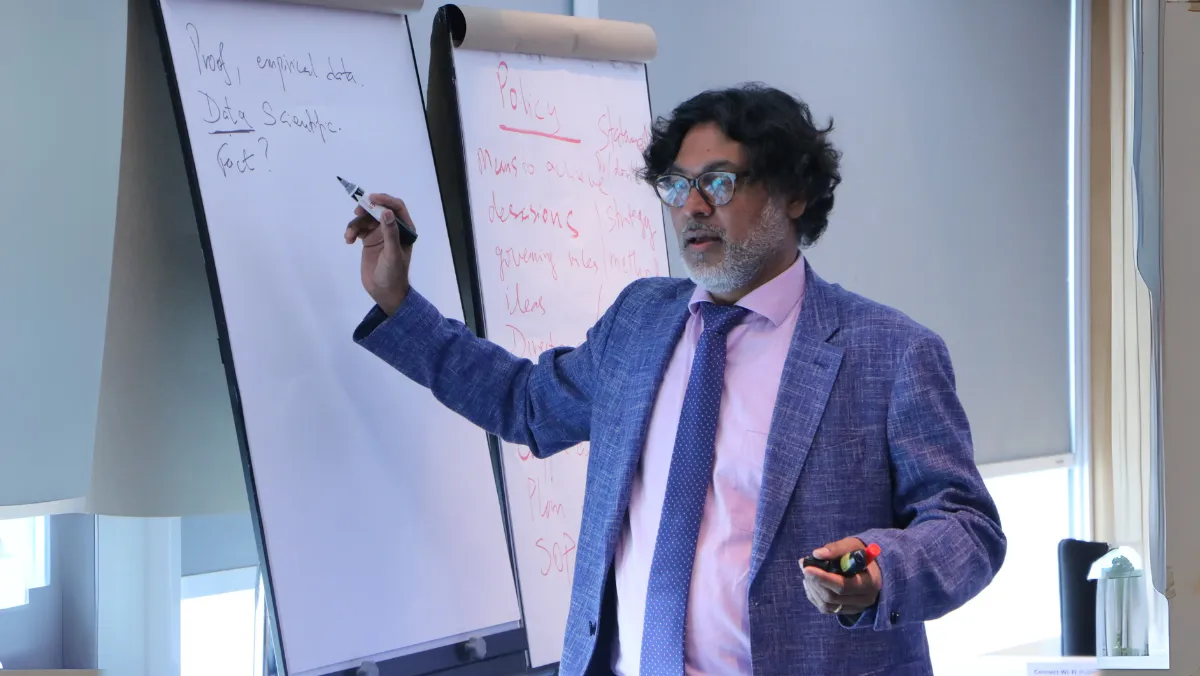 Naren Prasad, the trainer, engages with participants during the Evidence-Based Policy Making training in Bangkok on 9 December 2024.