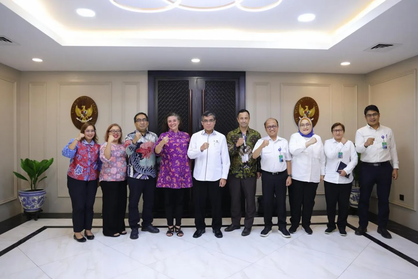 A group photo of 10 people standing, five female and five male.