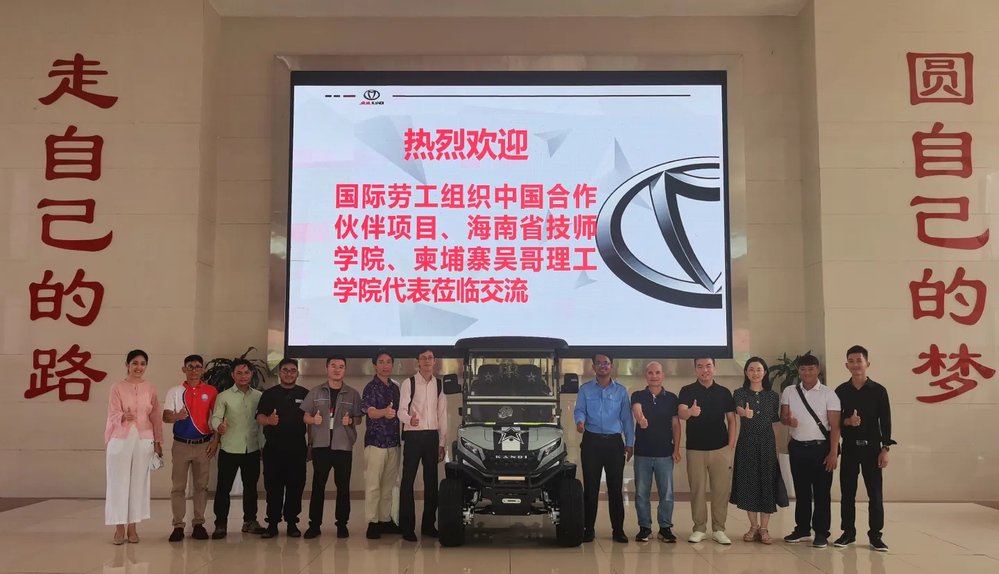 Group photo with an electric vehicle.