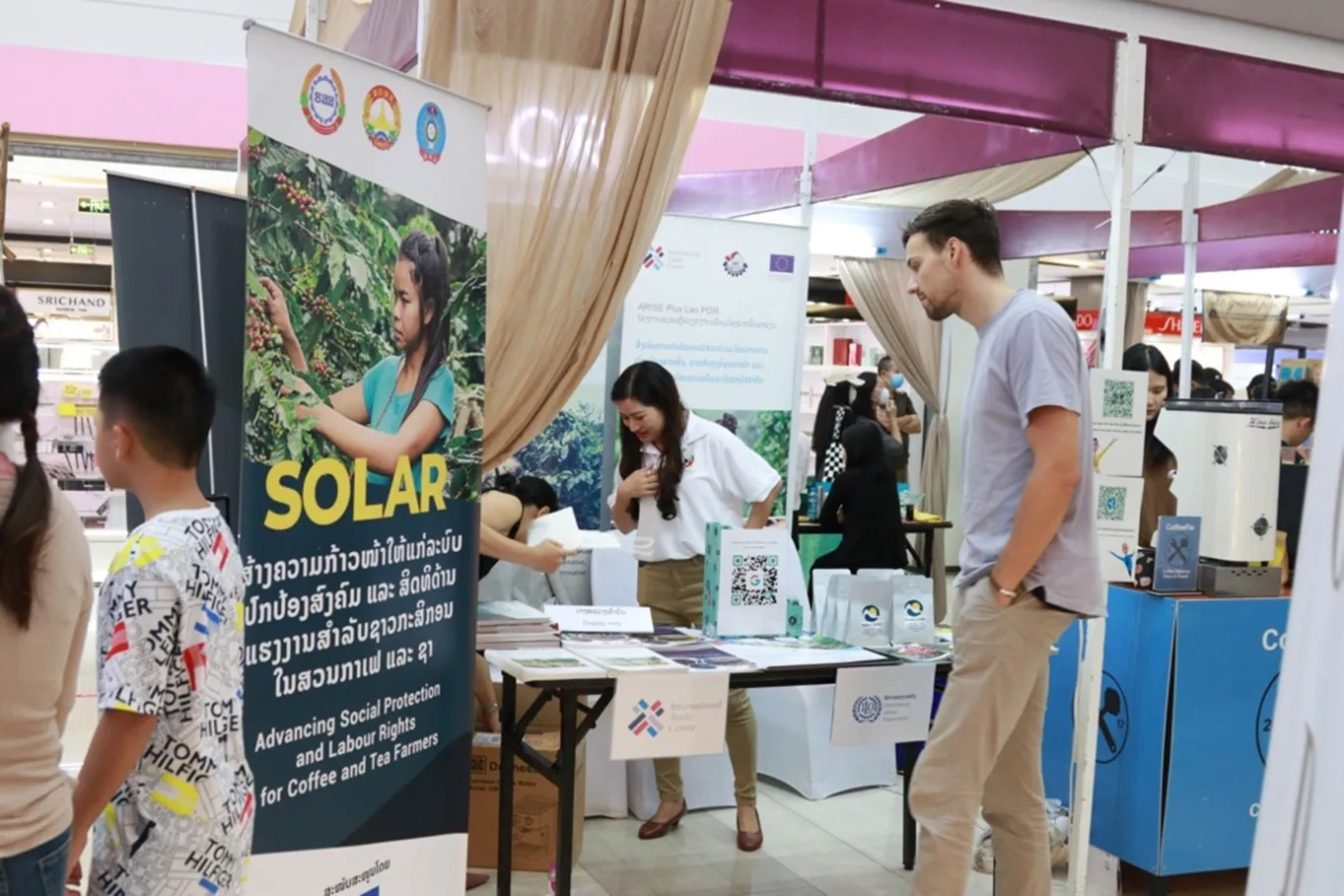 A visitor is reading information about the ILO's booth.