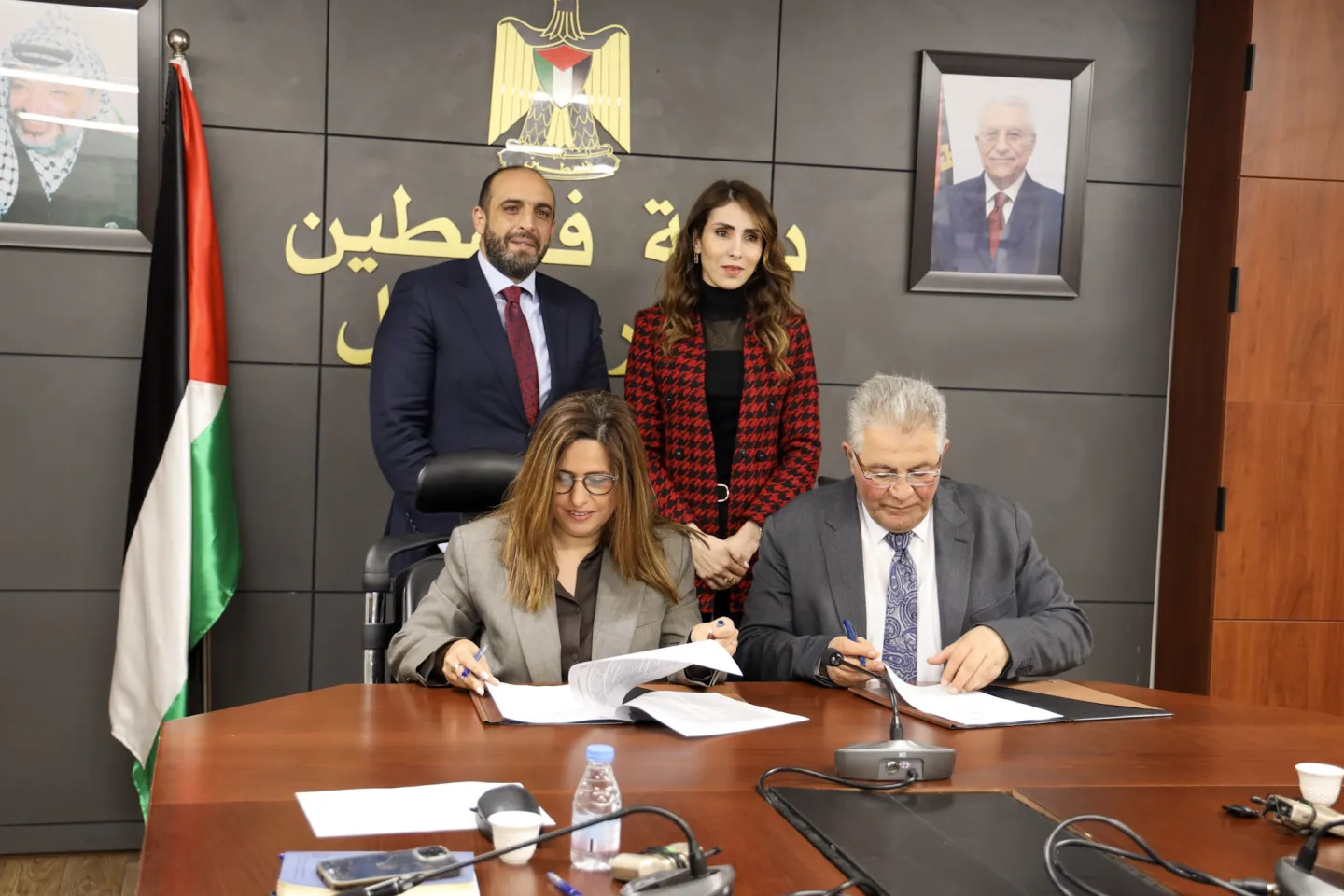 ILO OPT Officer in Charge, Ms. Rasha El Shurafa, and Al-Quds University President, Dr. Imad Abu Kishek, signing the strategic agreement.