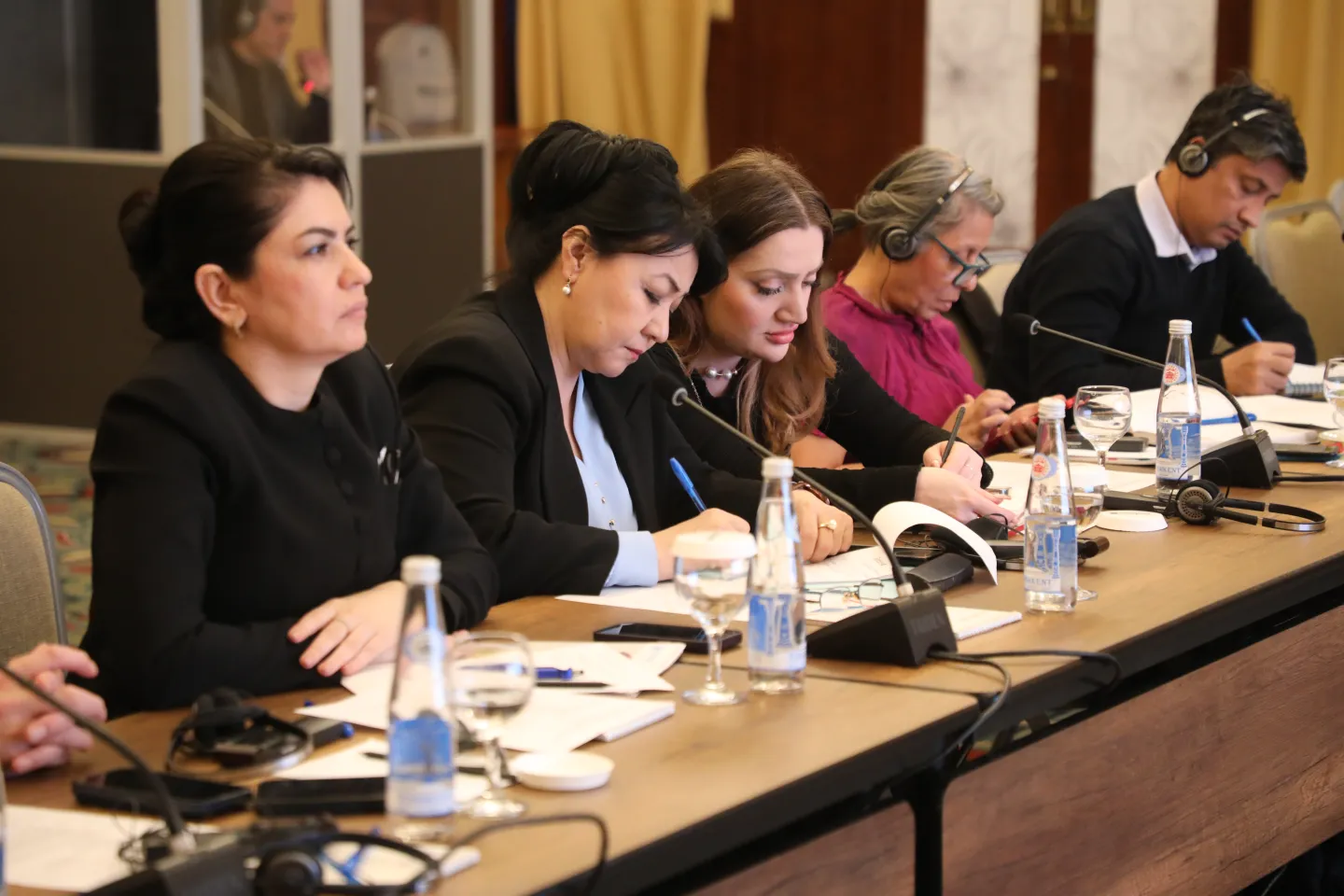 5 participants of the presentation on the 2024 cotton harvest monitoring sit at the table taking notes