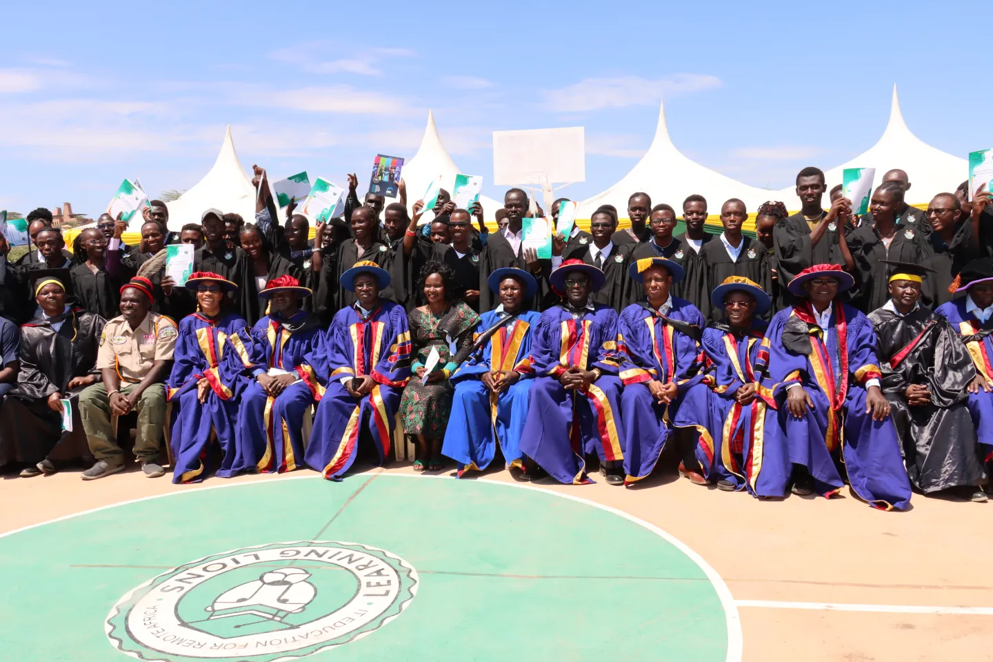 young men and women at the graduation ceremony in Kenya wearing the graduate trench sets