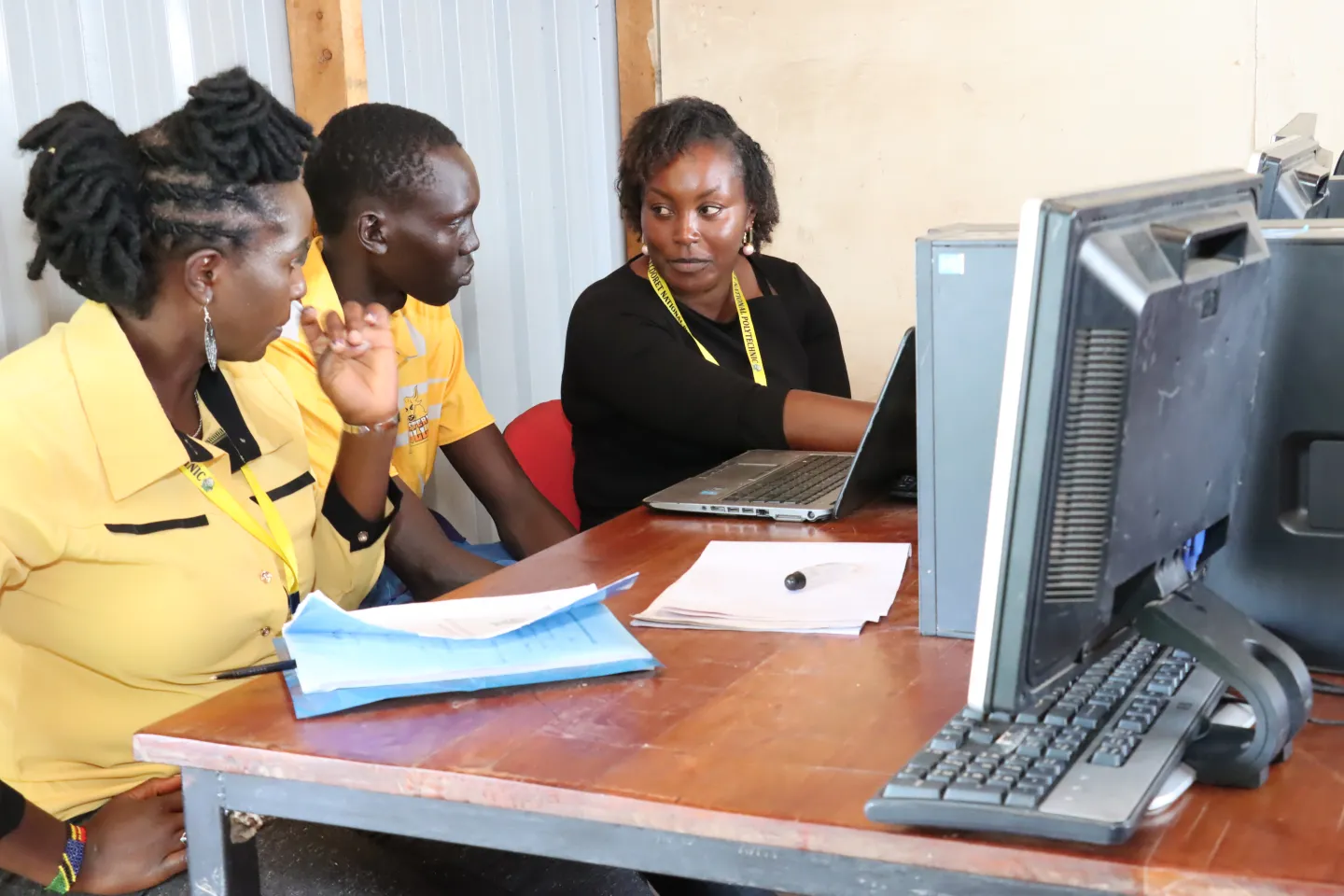student and teacher in front of computer 